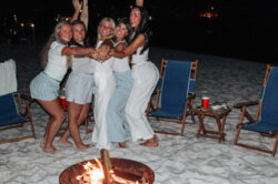 girls at beach bonfire